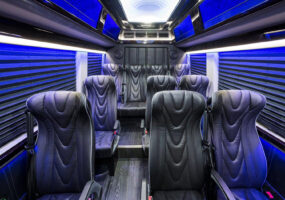 Interior view of executive coach sprinter shuttle with custom black leather interior