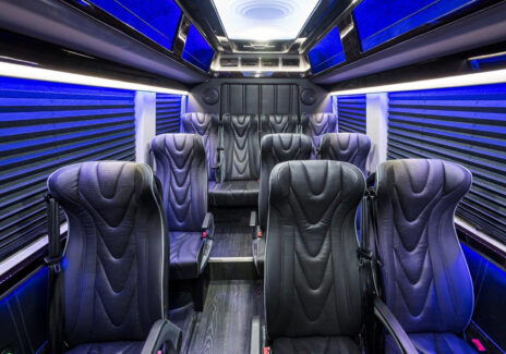 Interior view of executive coach sprinter shuttle with custom black leather interior