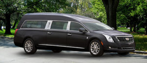 A profile view of a black funeral car hearse.