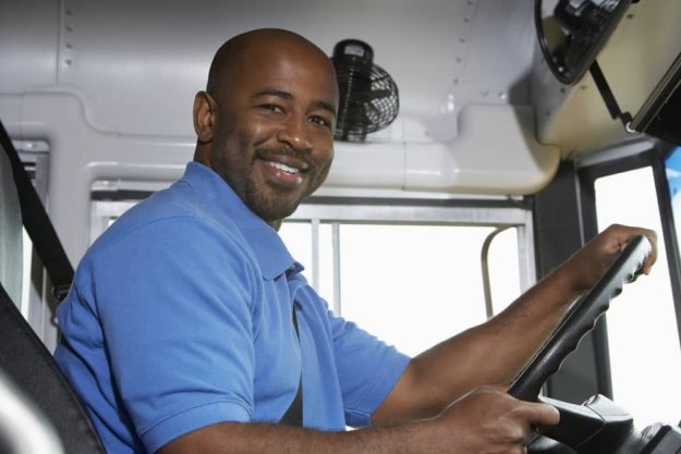 shutterstock_121422841 Man driving a coach bus