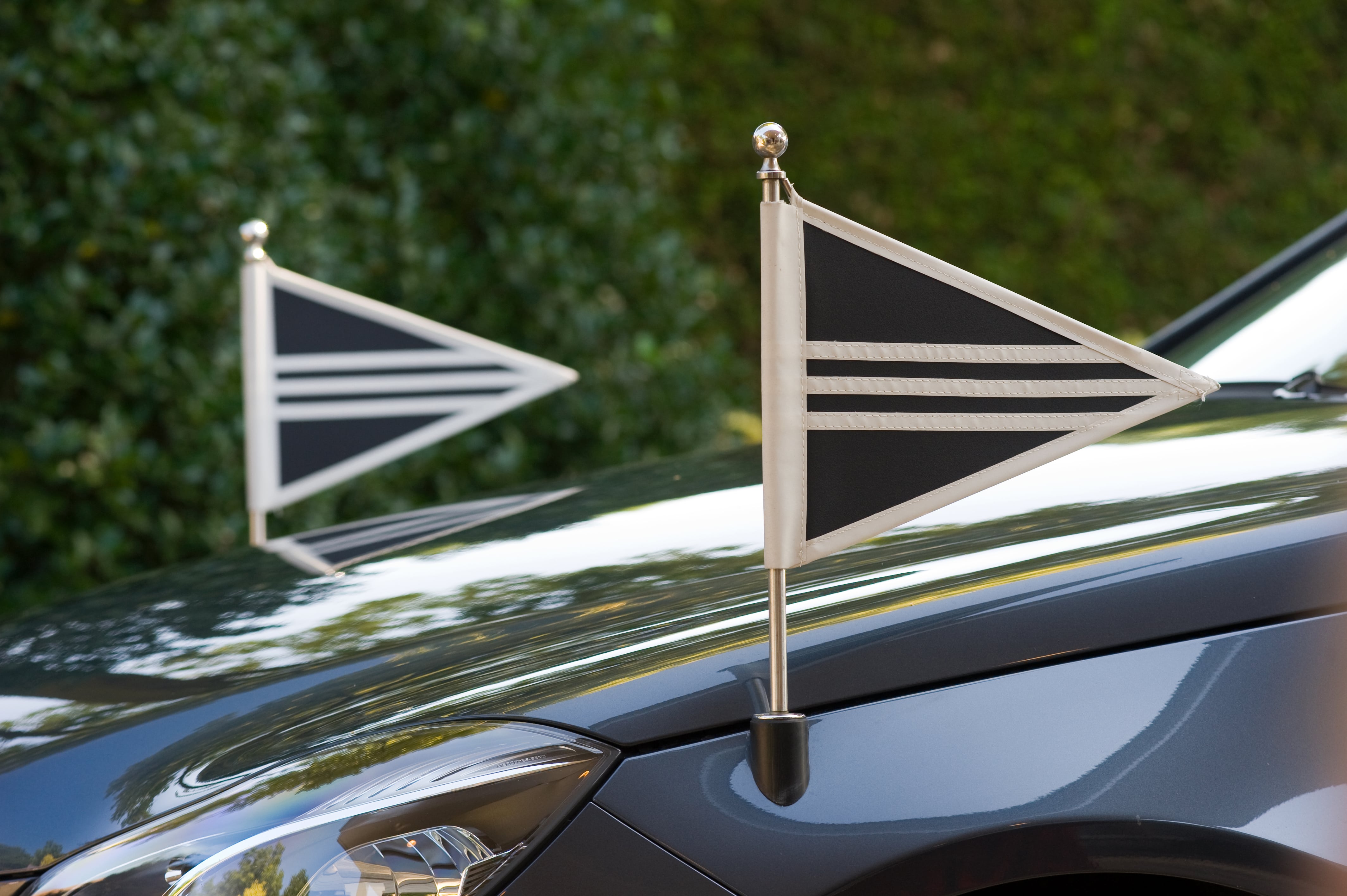 Flags on the front of a funeral car