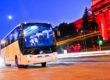 White coach bus driving at night