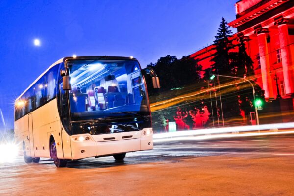 White coach bus driving at night