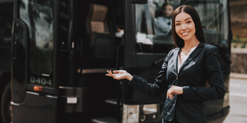 Female chauffeur in front of coach