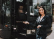 Female chauffeur in front of coach