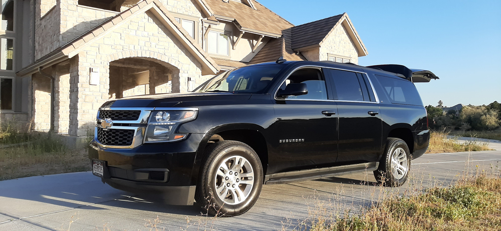 SUV limousine parked in a driveway SUV limousine parked in a driveway