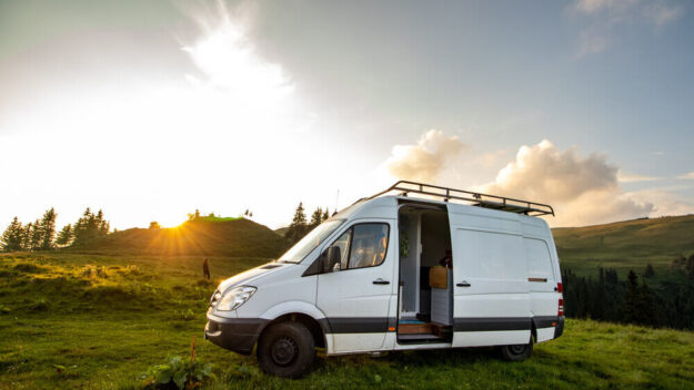 Luxury Mercedes sprinter van parked in a field