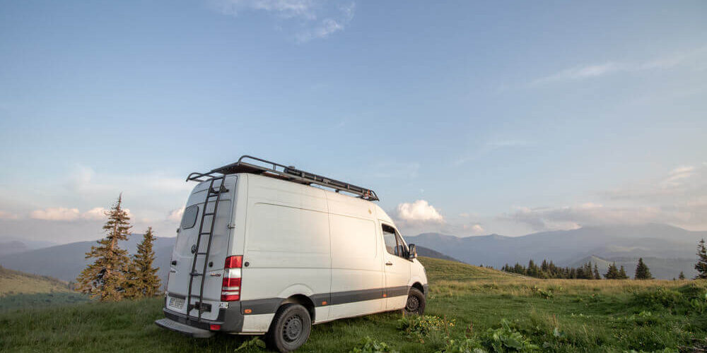 Sprinter Van with accessories Mercedes sprinter van parked in a field with ladder roof rack and other accessories.