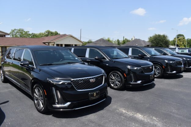 Row of black Cadillac funeral cars lined up for professional service use