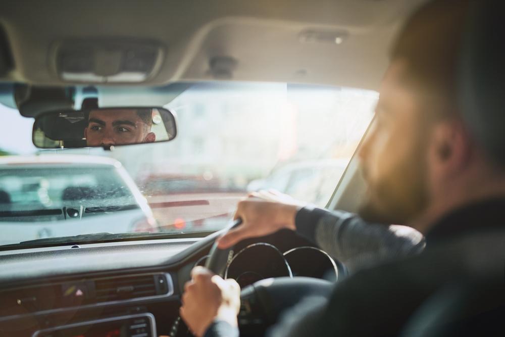 Driver maintaining awareness and focus while following traffic during a procession