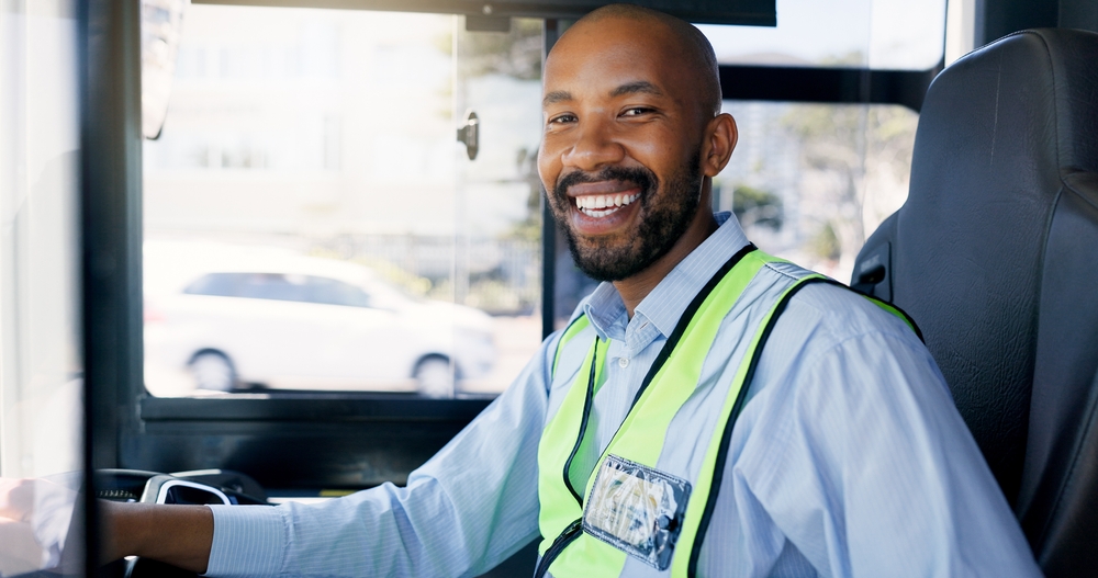 Smiling professional driver with a CDL license operating a bus