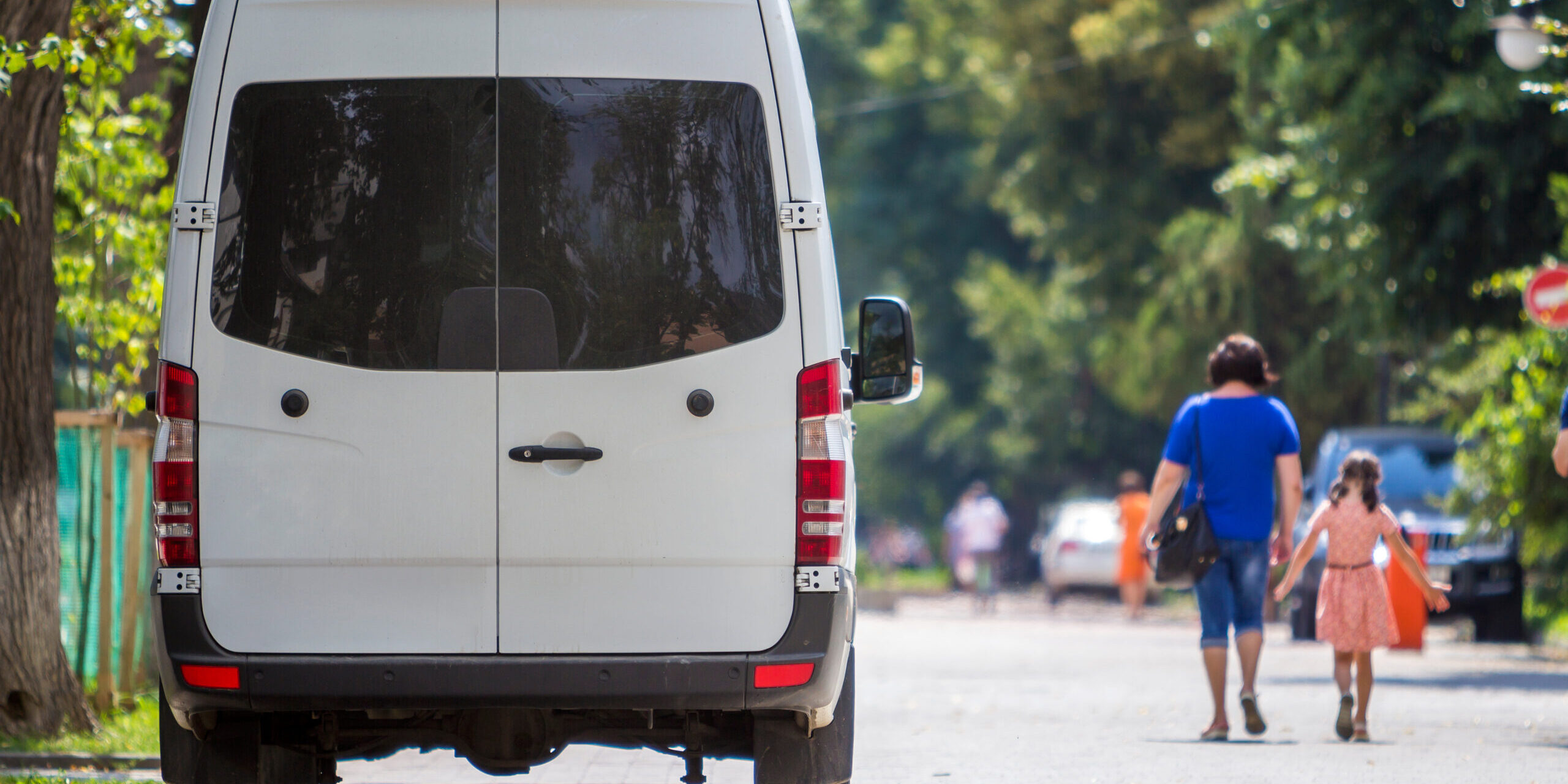 Rear view of a white Mercedes Benz sprinter van