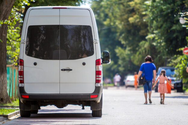 Rear view of a white Mercedes Benz sprinter van