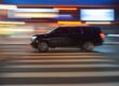 Fast moving black luxury SUV limousine