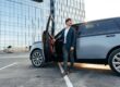 Man stepping out of a luxury SUV