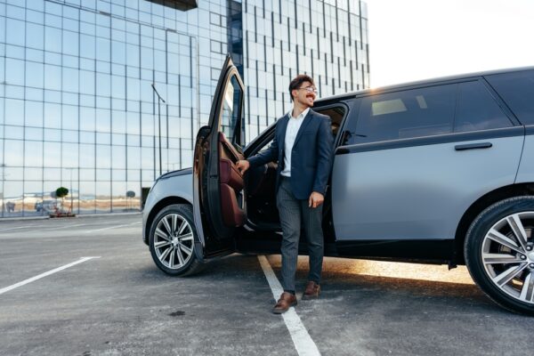 Man stepping out of a luxury SUV