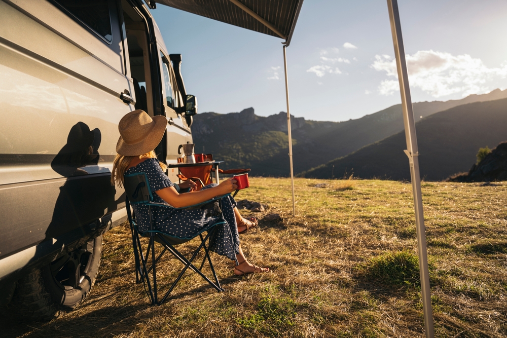 Woman enjoying van life outside her Sprinter van