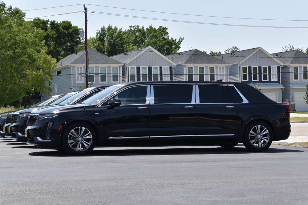 Black Cadillac funeral limousine for sale parked in a lot, extended model used for funeral services