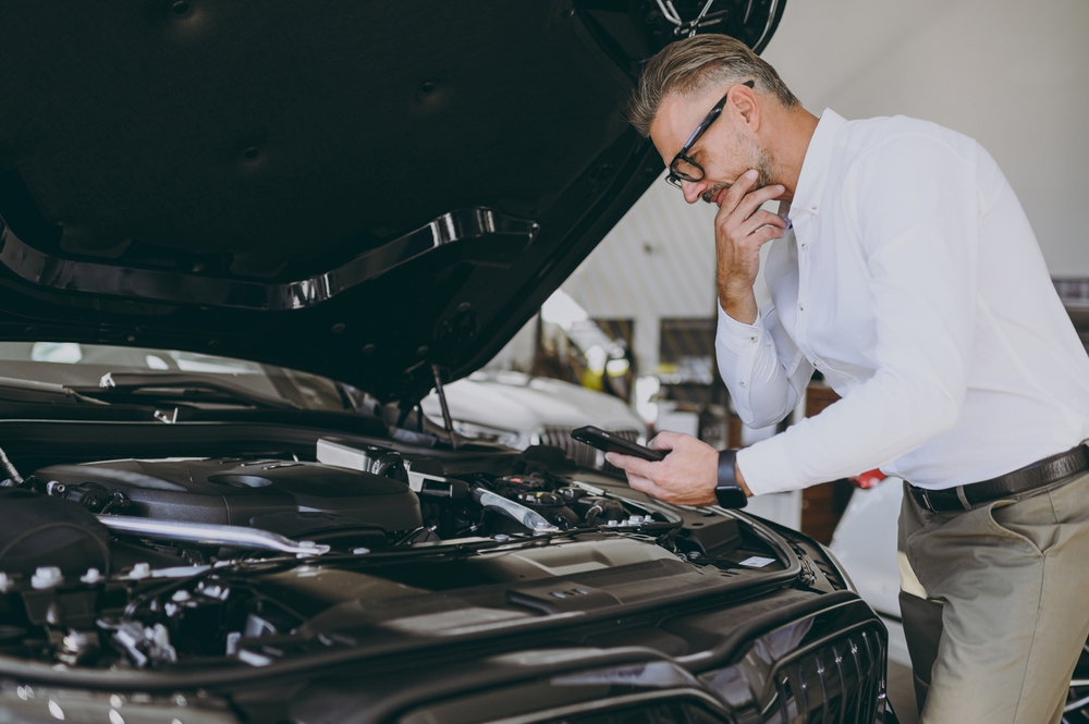 Man inspecting an SUV limo engine